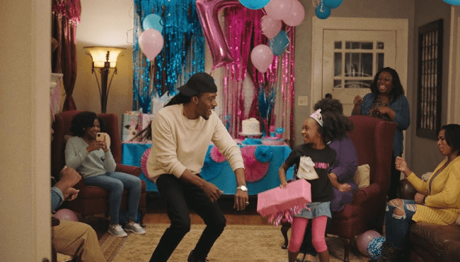 Black man dances at birthday party with little black girl at her birthday party
